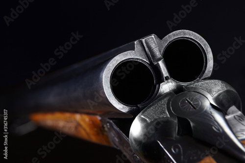 Foto Gun on black background.