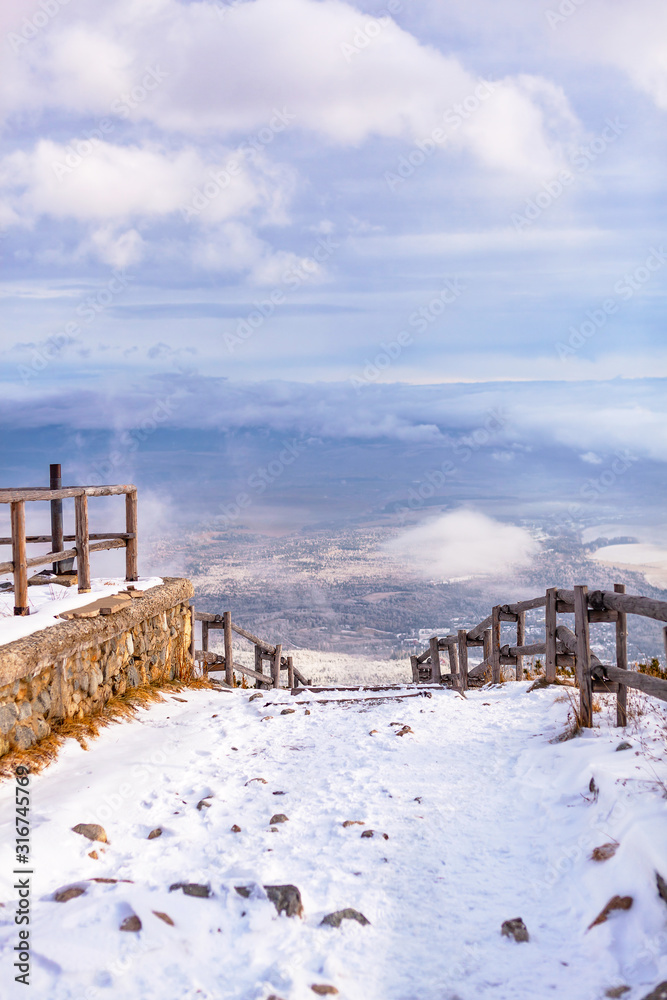 Trail in the High Tatras overlooking the clouds and meadow