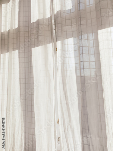 White cotton curtains on the wooden windows