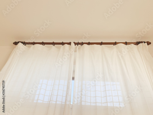 White cotton curtains on the wooden windows