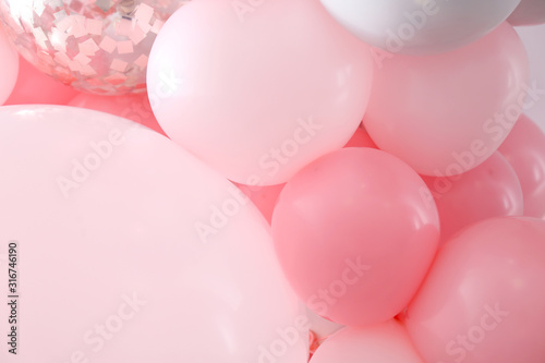 Beautiful colorful balloons on light background, closeup