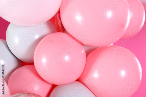 Beautiful colorful balloons on pink background, closeup