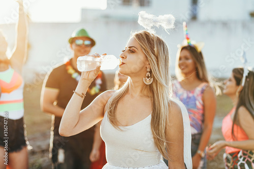 Photography Brazilian Carnival. Woman in costume drinking water