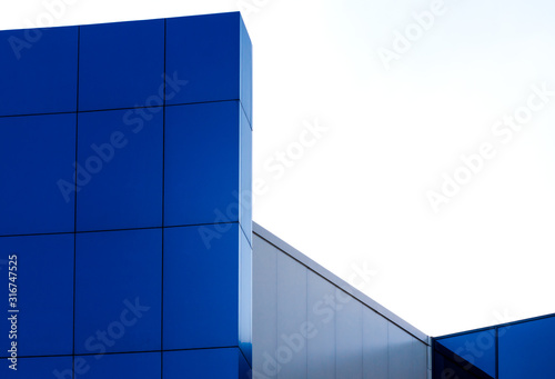 fragment of the wall of a modern blue building on a white background