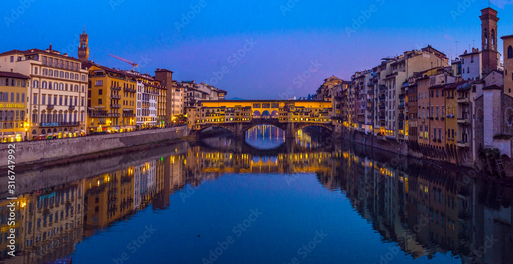 The Ponte Vecchio, famous medieval stone bridge over the Arno River in Florence, Tuscany, Italy.