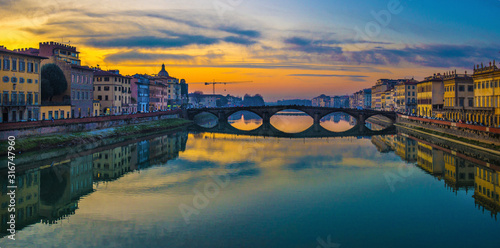 Florence, Ponte alla Carraia medieval Bridge landmark on Arno river at sunset. Tuscany, Italy. photo