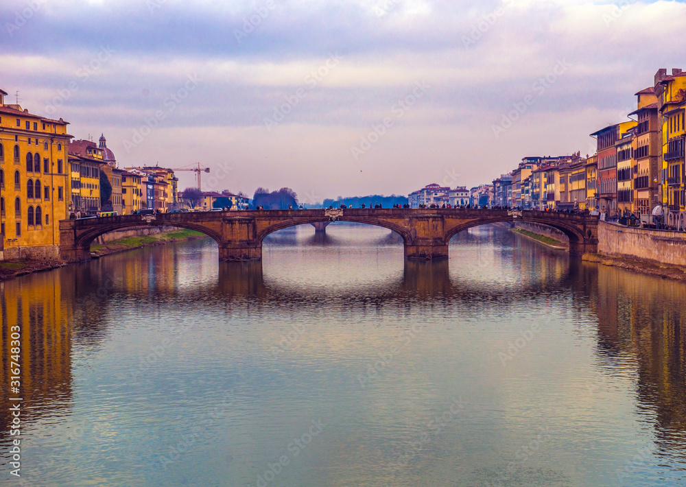 The Ponte Vecchio, famous medieval stone bridge over the Arno River in Florence, Tuscany, Italy.