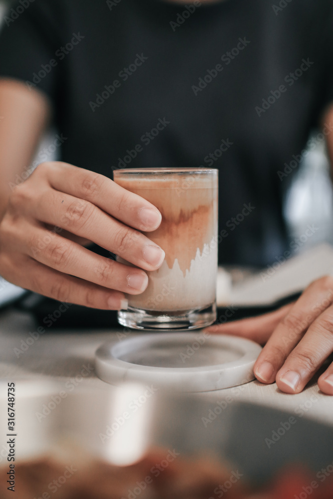 Hands holding hot cup of coffee or tea Close-up on background of a living room  with natural, beans, fresh air, aroma, good taste and relaxing in nature,