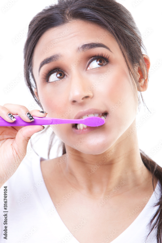 Portrait of young attractive woman brushing her teeth Portrait of young attractive woman brushing her teeth