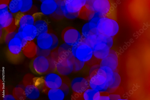 Bokeh and flare of blured background in nightclub. Fresh healthy blue red background with abstract blurred foliage and bright summer sunlight and a central copyspace for your text or advertismen photo
