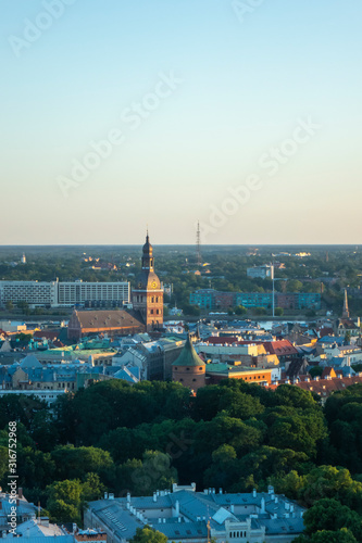 Riga Cathedral among old houses of town and green trees. © artjazz