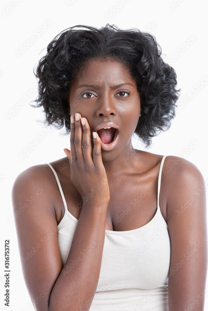 Portrait of an amazed African American young woman over white background Portrait of an amazed African American young woman over white background