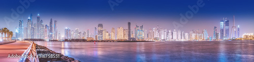 Panoramic cityscape view of skyscrapers and hotel buildings in the Dubai Marina area from the palm Jumeirah island in Dubai. Real estate and tourist attractions in the UAE