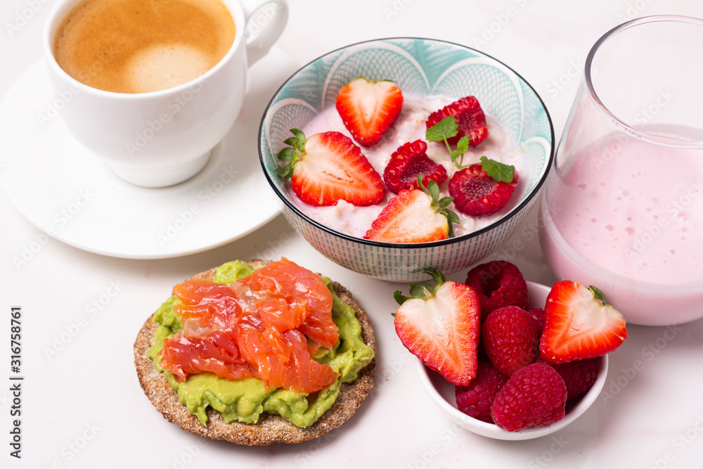 breakfast of porridge with berries, coffee and yogurt and toast top view breakfast of porridge with berries, coffee and yogurt and toast top view
