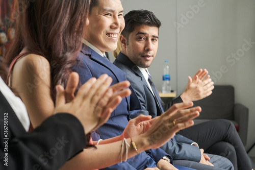 Businessmen and businesswomen working team success job creative clapping hand with smiling