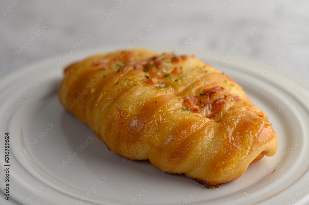 Sausage bread roll with hotdog on white plate