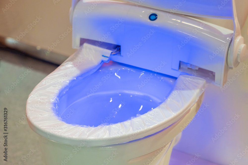 Washroom. Disposable pad on the rim of the toilet. Hygiene. Automatic