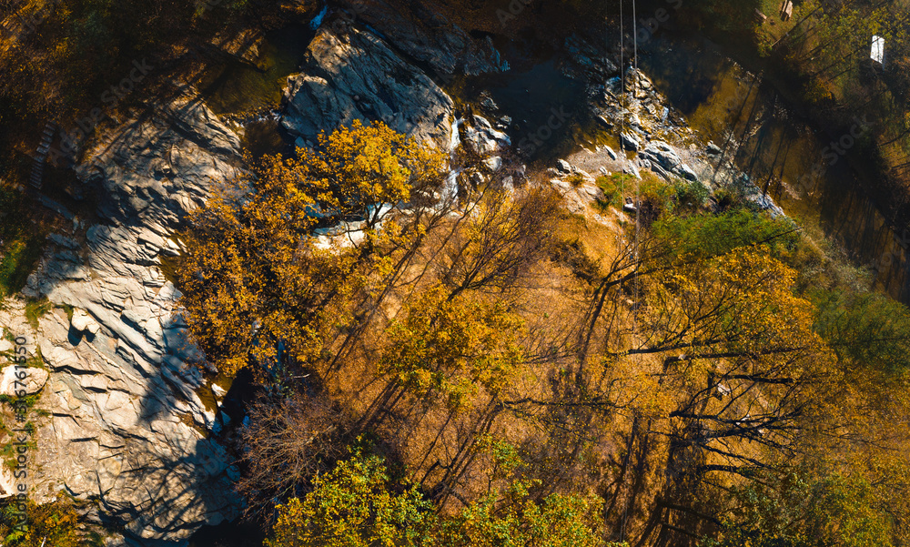 Aerial top down view of the Huk waterfall on the Pistynka River, surrounded by the Carpathian mountains. The beautiful nature. Sunny autumn day. Sheshory, Ukraine Aerial top down view of the Huk waterfall on the Pistynka River, surrounded by the Carpathian mountains. The beautiful nature. Sunny autumn day. Sheshory, Ukraine