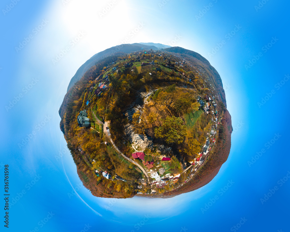 Little planet aerial view of the village of Sheshory, surrounded by the Carpathian mountains. Buildings and infrastructure. The nature of Ukraine. Sunny autumn day. Huk waterfall Little planet aerial view of the village of Sheshory, surrounded by the Carpathian mountains. Buildings and infrastructure. The nature of Ukraine. Sunny autumn day. Huk waterfall