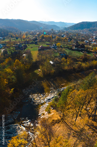 Aerial view of the Huk waterfall on the Pistynka River, surrounded by the Carpathian mountains. The beautiful nature. Sunny autumn day. Sheshory, Ukraine photo