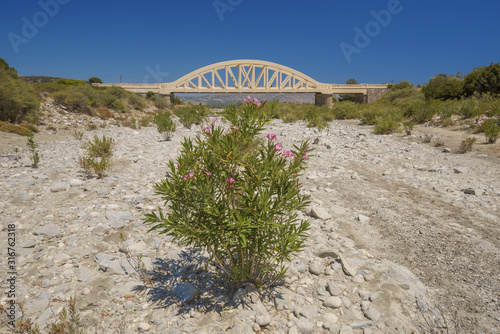 Bridge over a ragged river, Rhodes, Greece photo