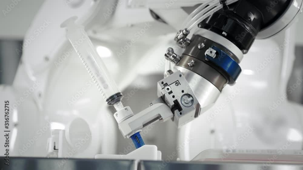 The innovative arms of a robotic arm make an injection of chemotherapy for a cancer patient. New technologies in medicine. Two manipulators draw medicine into a syringe. Hazardous substance injected.