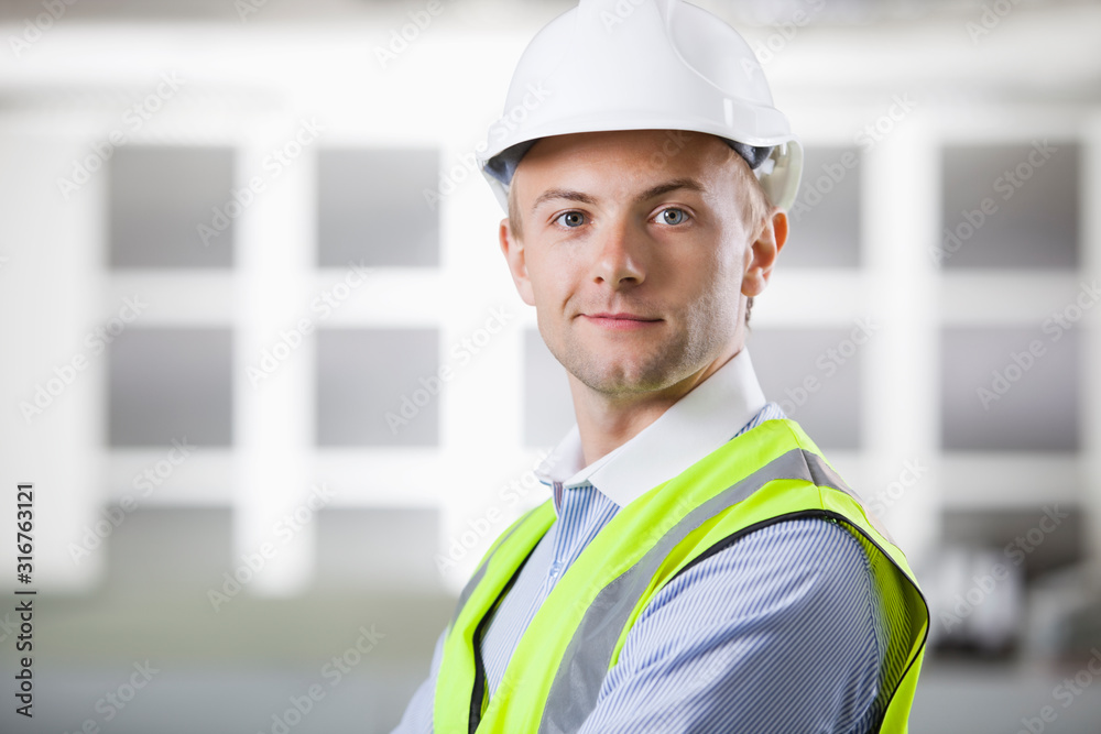 Portrait of confident young Caucasian architect smiling Portrait of confident young Caucasian architect smiling