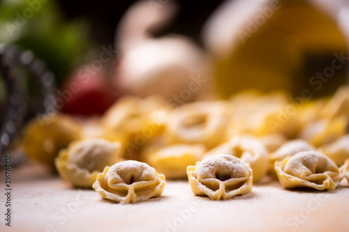 Tortellini or Tortelloni pasta on a flour dusted board photo