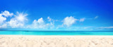 Beautiful beach with white sand, turquoise ocean water and blue sky with clouds in sunny day. Panoramic view. Natural background for summer vacation.