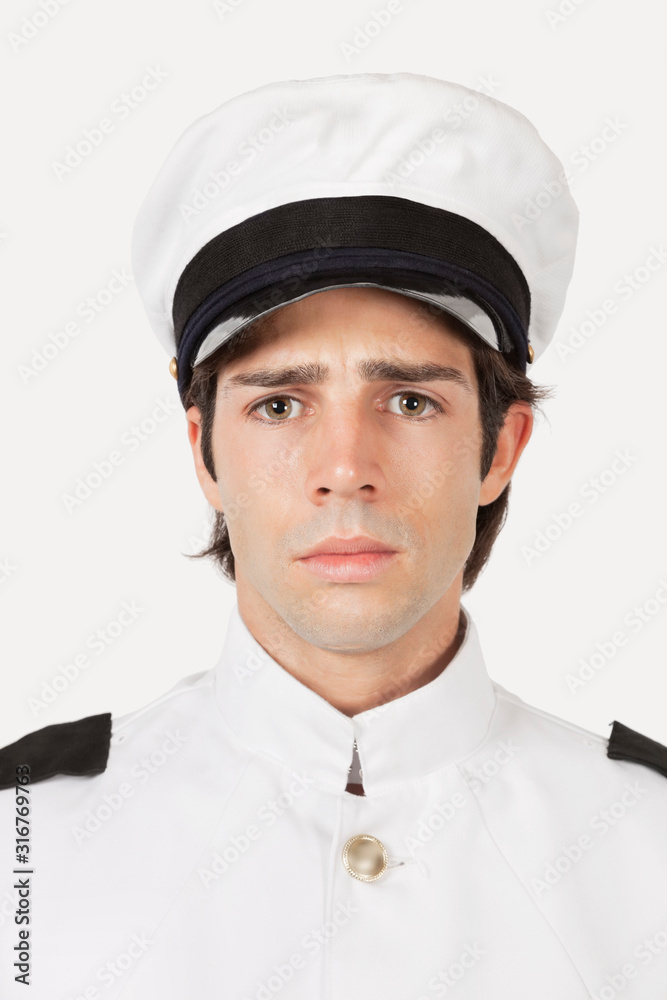 Portrait of young sad navy officer against gray background Portrait of young sad navy officer against gray background