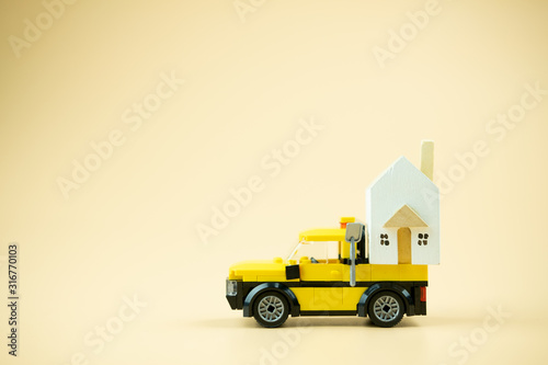 House on toy truck. Moving to new house concept.