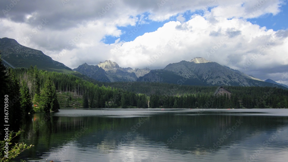 Late summer in Strbske Pleso, Slovakia, High Tatras. A winter and tourist resort located on the lake with the same name. Strbske Pleso lake with a mountain view 
