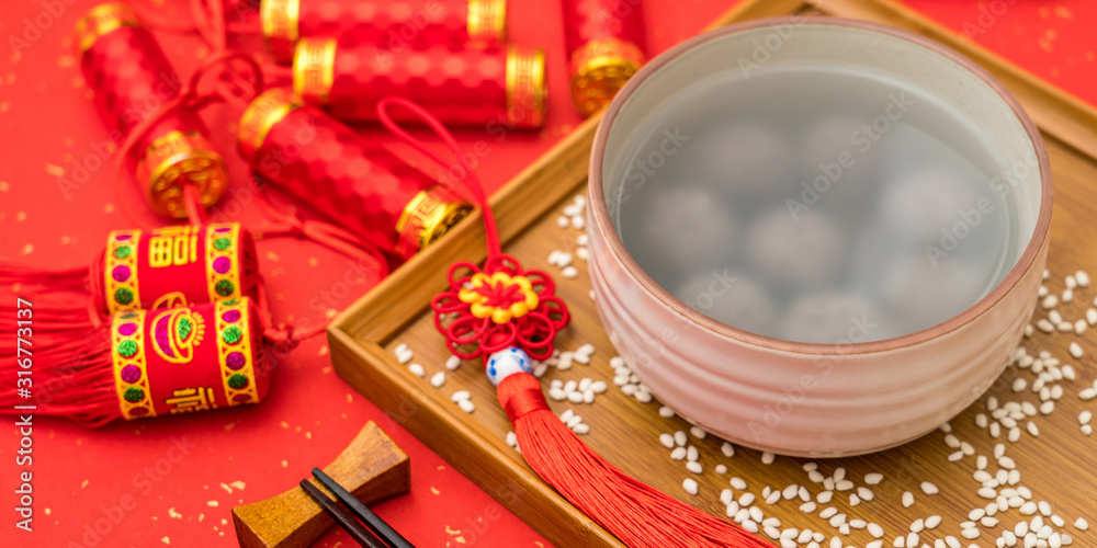 Chinese Lantern Festival traditional food black sesame dumplings on red background Chinese Lantern Festival traditional food black sesame dumplings on red background