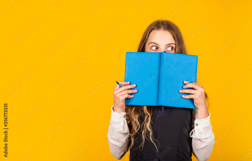 Looking for relevant information. Little girl cover face with book. Information and education. School library. Published information. For more information, copy space Looking for relevant information. Little girl cover face with book. Information and education. School library. Published information. For more information, copy space