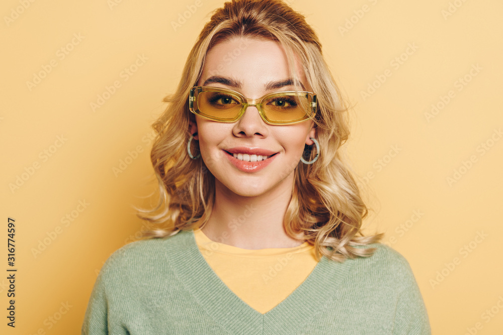 beautiful, happy girl in glasses smiling at camera on yellow background beautiful, happy girl in glasses smiling at camera on yellow background