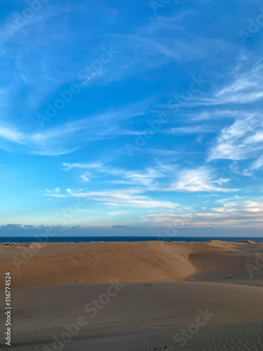Sahara Morocco dunes and desert landscape with beautiful sky and clouds sunset