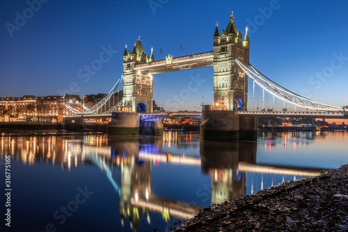 Tower Bridge with reflection in Thames river during twilight  London  UK