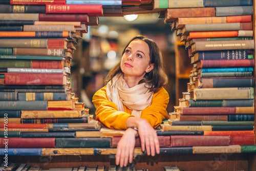 Attractive young girl in a bookstore photo