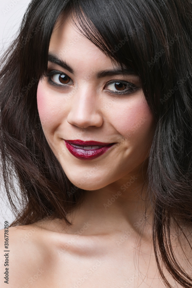 Close-up portrait of mixed race young woman over white background Close-up portrait of mixed race young woman over white background