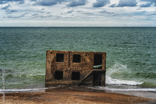 Fototapeta Naklejka Na Ścianę i Meble -  Fragments with windows and stairs of an old fort in the Baltic Sea in summer. Liepaja, Latvia