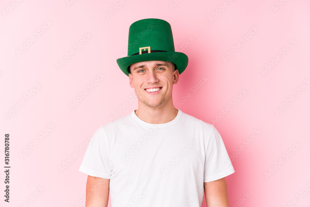 Young caucasian man celebrating saint patricks day happy, smiling and cheerful. Young caucasian man celebrating saint patricks day happy, smiling and cheerful.