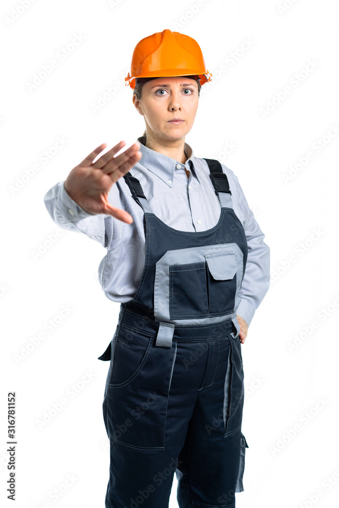 Worker woman making stop sign with her palm wearing protection equipment at job. Isolated Worker woman making stop sign with her palm wearing protection equipment at job. Isolated