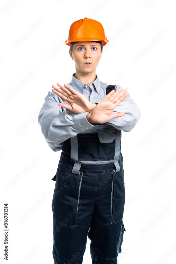girl construction worker builder in orange hard hat showing stop sign hand gesture. Isolated girl construction worker builder in orange hard hat showing stop sign hand gesture. Isolated