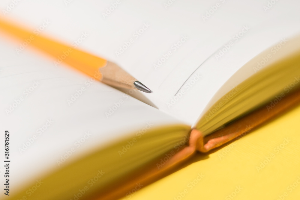 custom made wallpaper toronto digitalA pencil between pages of the daybook on the yellow background. Concept photo.