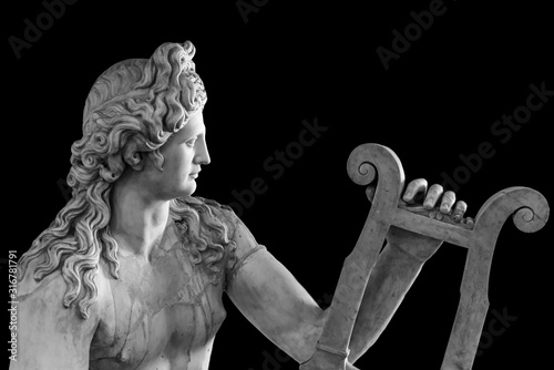 Ancient roman statue of God Apollo playing a lire - black and white photo