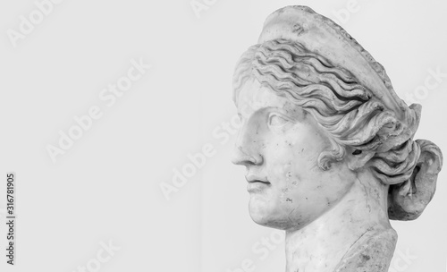 Profile of female young roman statue - black and white photo with closeup