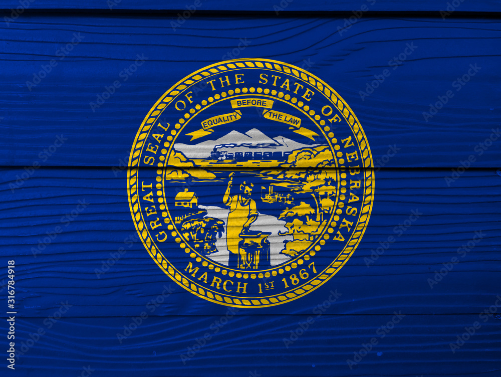 Nebraska flag color painted on Fiber cement sheet wall background. Seal of Nebraska in gold on an azure field.