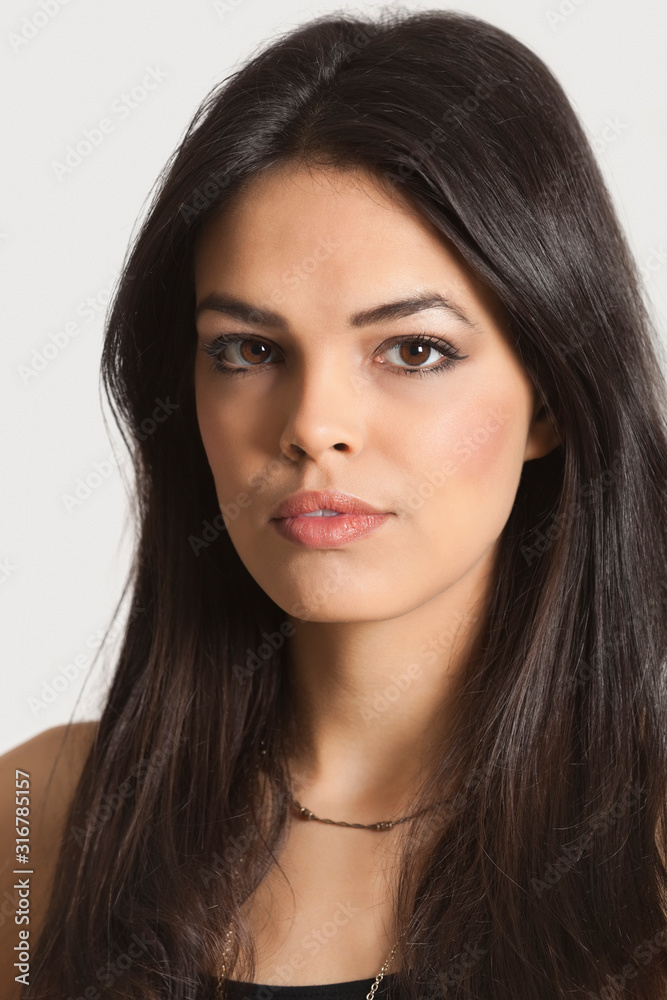 Close-up portrait of young woman over white background Close-up portrait of young woman over white background