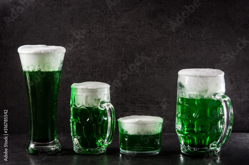 Traditional St Patrick's Day green beers on black background. 