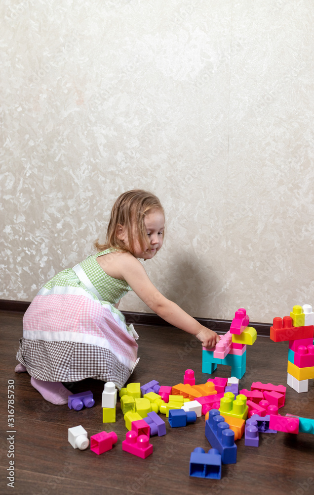 The child plays in the constructor. the child builds from the designer figures of animals and robots The child plays in the constructor. the child builds from the designer figures of animals and robots